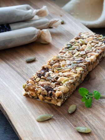 Superfood breakfast homemade bars with oats and seeds, on wooden backgroundの写真素材