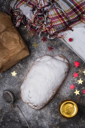 Traditional European Christmas pastry, home baked stollen, with powder sugar. Dark background.の写真素材