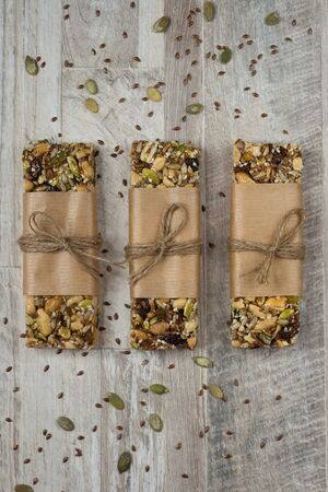 Superfood breakfast bars, healthy granola bars with nuts, seeds and dried fruits. Vertical view, top view, flat layの写真素材