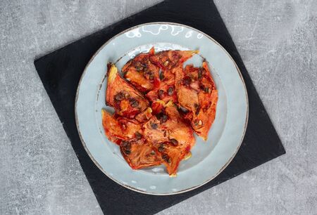 Sun-dried watermelon on a plate top view, vertical veiw