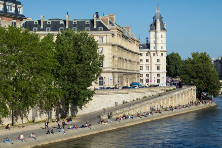 People are enjoying their free time on the banks of river Seine, in Paris, Franceのeditorial素材