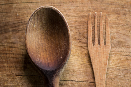 Wooden fork and spoon on a wooden plankの写真素材
