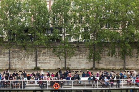 Paris, France - May 15, 2015: A crowd of people takes a boat ride on the river Seine in Paris, France.のeditorial素材