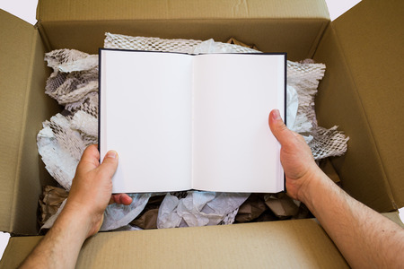 Hands unboxing new notebook with white pages
