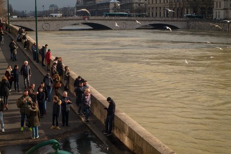 Paris, France - January 27th, 2018: Tourists take pictures of the flooded river Seine, in Paris, France.のeditorial素材