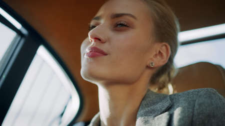 Close up sexy business woman relaxing at car. Beautiful female professional dancing at backseat in...