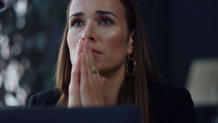 Closeup thoughtful businesswoman sitting at remote workplace. Stressed female professional holding...