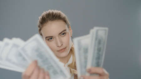 Cash money count concept. Business woman counting money cash in slow motion. Portrait of young woman...