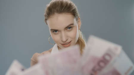 Rich business woman counting money cash in slow motion. Successful woman counting euro banknotes on...