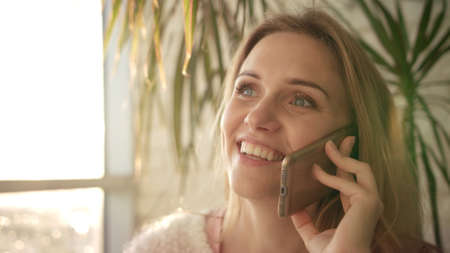 Beautiful woman talking mobile. Close up of speaking woman face with telephone. Smiling girl...