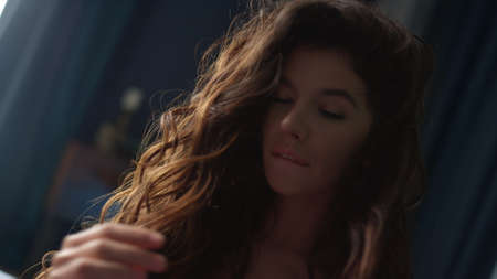 Portrait of long hair woman fooling around in slow motion indoors. Closeup pretty girl looking...