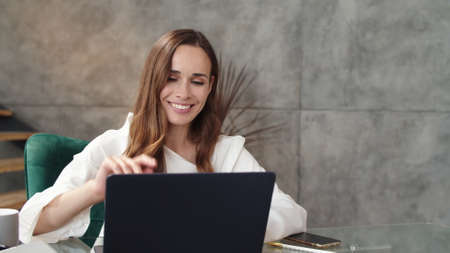Closeup smiling business lady making conference call at office. Portrait of cheerful girl working...