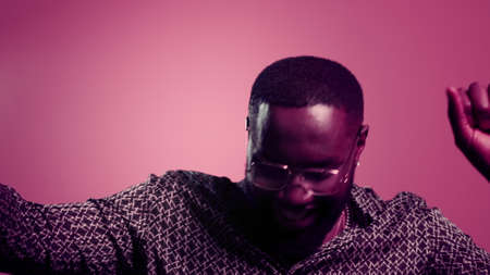 Closeup sensual afro male person making movements indoors. Portrait of attractive african guy moving...
