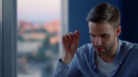 Portrait of thoughtful business man thinking about startup in coworking. Closeup pensive man waiting for inspiration in creative office. Young professional thinking ideas in office.の写真素材