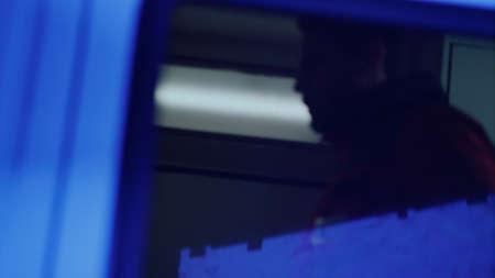 Silhouette of unrecognizable paramedic standing in emergency car. Ambulance car arriving at traffic...