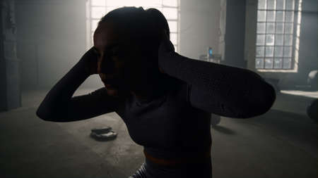 Silhouette sport girl training abs muscles in fitness gym. Female athlete abs crunches exercise....
