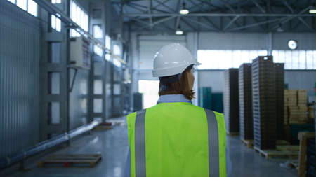 Worker checking factory warehouse inspecting shipment process analysing delivery. Woman storage...