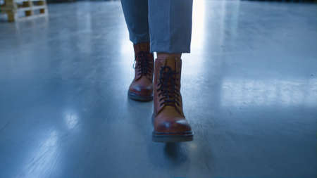 Closeup factory worker walking workplace working in manufacture storehouse. Close up warehouse...