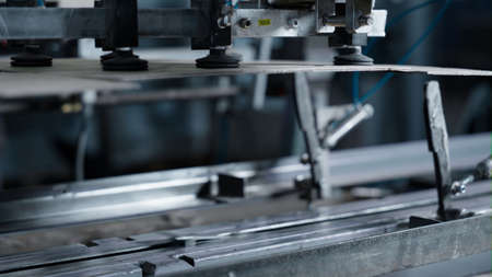 Closeup cardboard crate production process in manufacturing factory facility. Modern warehouse line...