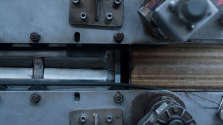 Closeup factory conveyor automat with metal parts in manufacturing facility. Technological...