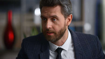 Serious business man talking discussing work information in marketing corporation office. Close up...