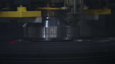 Closeup tyre stamping machine working process at technological manufacture. Modern conveyor line manufacturing black rubber automobile tire spinning in workshop. Automotive equipment producing conceptの写真素材