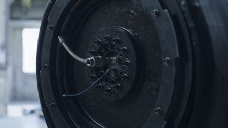 Rubber tyre production machine in technological automotive factory closeup. Close up tire...