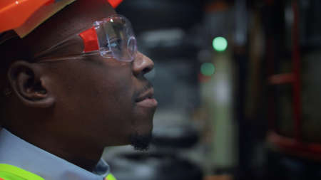 Joyful industrial supervisor talking at energy production facility. Man engineer smiling at...