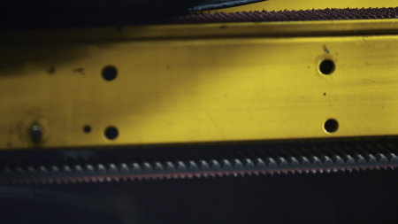 Closeup tire stamping conveyor spinning rubber tape in technological factory. Modern industrial automated tyre production technology with robotic line working at workshop. Automotive industry conceptの写真素材