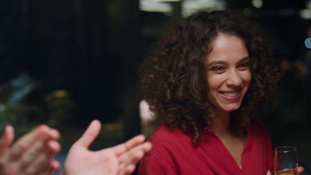 Mixed race group dancing on restaurant celebration party. Close up friends drinking in fine dining place. Cheerful people adults enjoying dance party in evening cafe bar. Fun leisure together concept.の写真素材