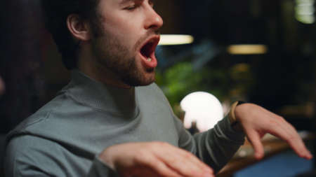 Drinking man having fun on fancy restaurant meeting. Cheerful guy making dance moves on cafe celebration party close up. Friends enjoy hanging out in loft interior bar. Leisure weekend dancing conceptの写真素材