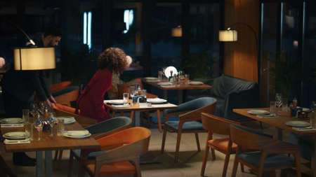 Multiracial couple going out on dinner date in night luxury restaurant cafe. Two sexy people...