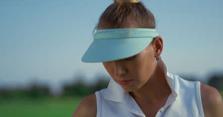 Golf player enjoy country club at green course. Portrait of attractive woman golfer looking sunlight...