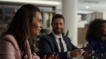 Multi ethnic business group discuss marketing project in office building. Woman executive talking explaining financial strategy plan on conference meeting. Professional corporate communication conceptの写真素材