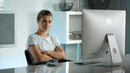 Focused businesswoman watching online show at home. Corporate manager at work. Confident beautiful...