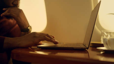 Stressed manager browsing laptop closeup. Focused african american touching pad working on business...