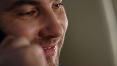 Man talking phone airplane closeup. Smiling passenger looking aircraft window. Happy manager ceo calling speaking cellphone on business trip. Thinking businessman finishing mobile conversation.の写真素材