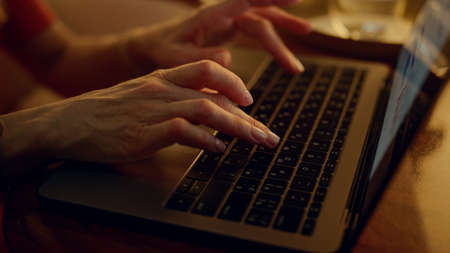 Successful lady browsing online on corporate trip. Hands typing keyboard closeup. Attractive focused...