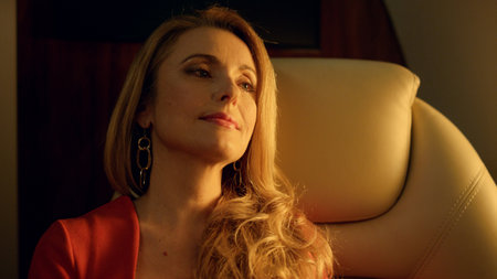 Beautiful woman dreaming alone in golden sunlight closeup. Relaxed lady enjoying calm peaceful...