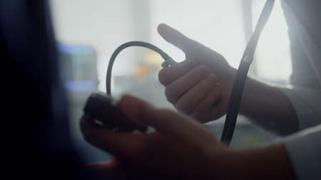 Physician hands measure blood pressure with pear tonometer unknown patient close up. Unrecognizable...