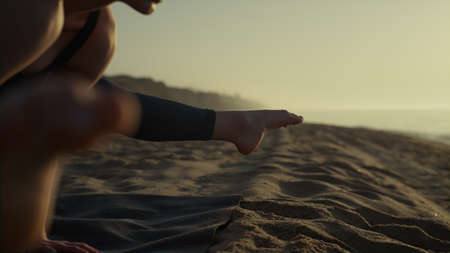 Yogi girl practicing crane position standing on hands outside. Athletic sportwoman making gymnastic...