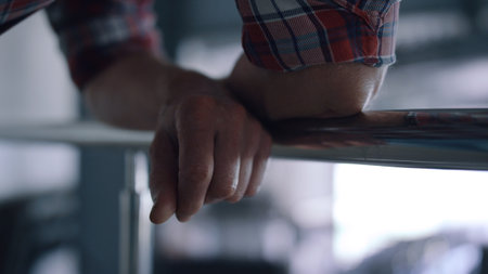 Closeup engineer hands laying railings in robotic modern cowshed. Unknown farm specialist standing...
