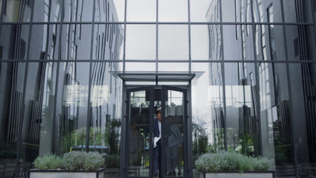 Frustrated businessman throwing papers at office entrance. Team failure concept. Annoyed...