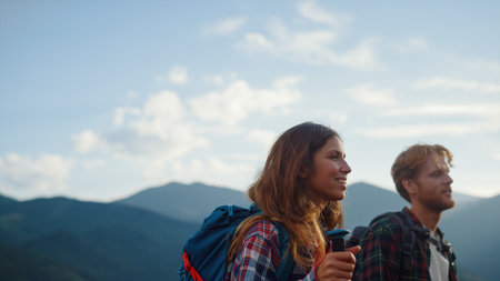 Closeup smiling couple backpack in summer mountains. Happy hikers walk nature outside. Two travelers...