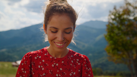 Closeup smiling pretty woman posing in front mountains summer holiday. Portrait of happy girl...