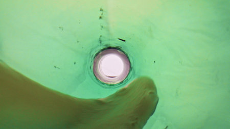 Cold ale filling glass closeup. Unfiltered alcoholic liquid bubbling inside clean goblet super slow...