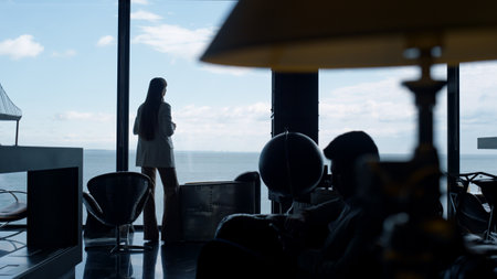 Relaxed businesswoman silhouette thinking in sea view office. Unrecognized leader person watching...