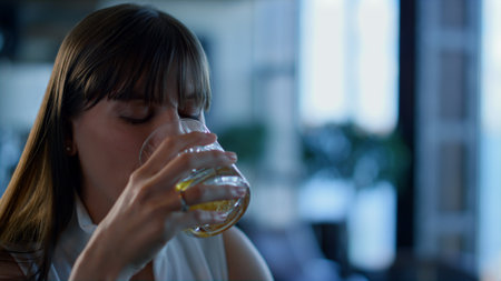 Closeup businesswoman drinking whiskey in bar. Ceo person resting and talking at formal dinner hotel...