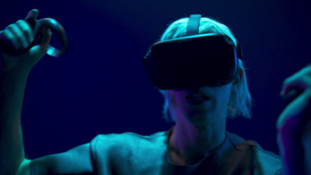 Scared man playing handheld trackpads videogame closeup. Nervous gamer using gadget for virtual...