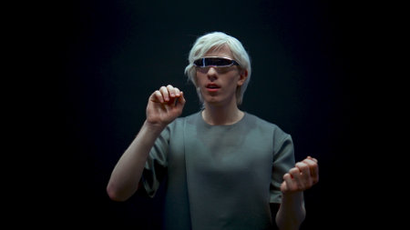 Excited man playing vr in futuristic glasses closeup. Happy teenager enjoying simulation in dark...